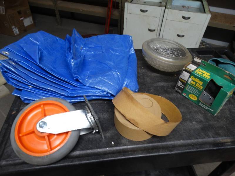 lot 8605 image: Tarp, cieling fan box and a large caster wheels.