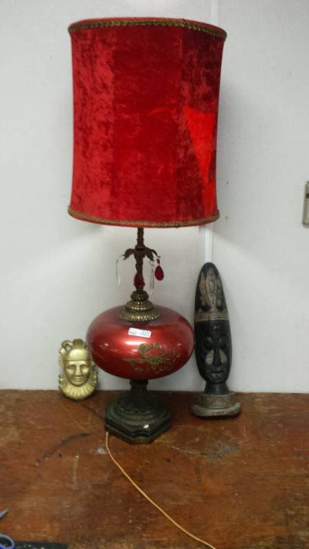 lot 2122 image: Vintage Red Lamp and Shade, Two Mask Dcor Items