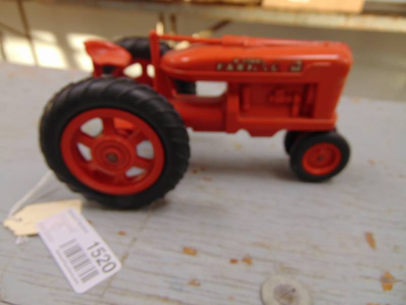 lot 1520 image: McCormick Farmall Tractor toy - Plastic - Seat Chipped
