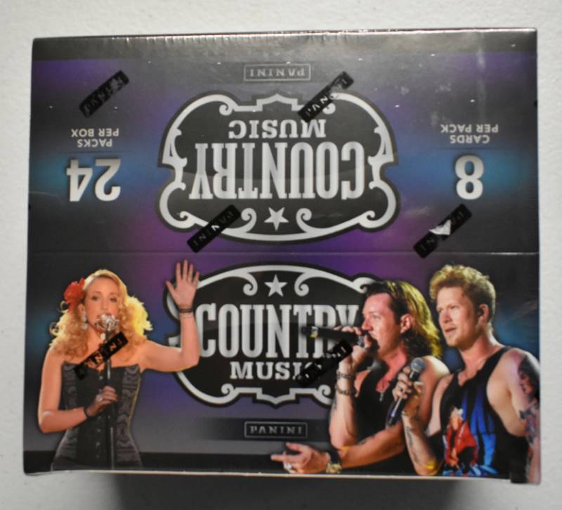 lot 1026 image: Factory Sealed Box 2013 Panini Country Music with 24 Packs - 8 Cards per Pack - Two Autographs or Relics In the Box