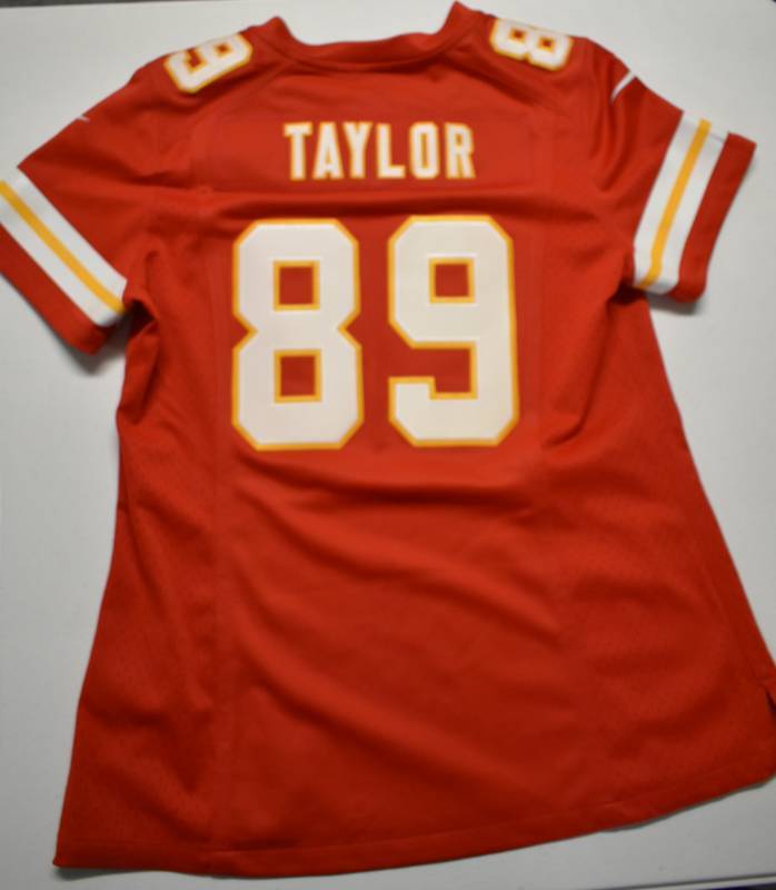 lot 1063 image: Brand New Kansas City Chiefs Otis Taylor #89 Womans New In Box Kansas City Chiefs Jersey - Size Medium - Given Away By Chiefs & Clark Hunt
