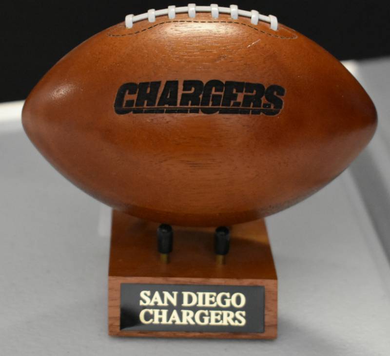 lot 1084 image: San Diego Chargers National Football League Wooden Team Logo Football With Stand - 5 Inches Wide - With Metal Team Name Plaque