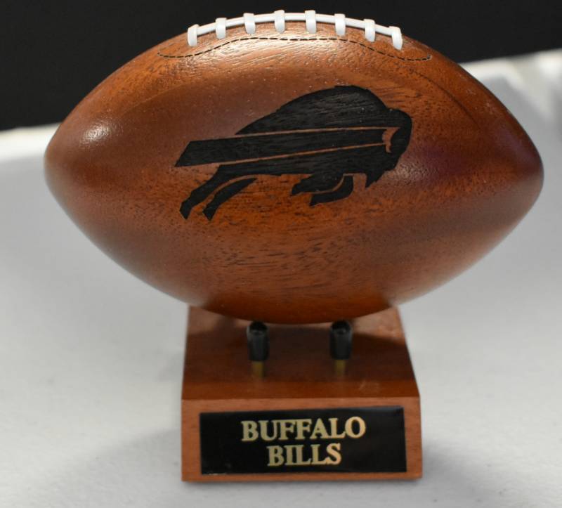 lot 1087 image: Buffalo Bills National Football League Wooden Team Logo Football With Stand - 5 Inches Wide - With Metal Team Name Plaque