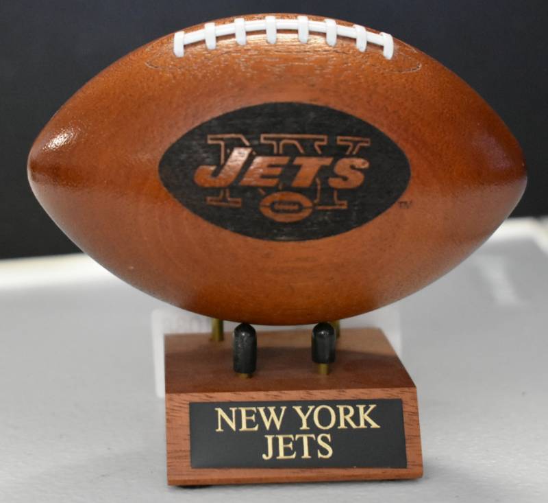 lot 1088 image: New York Jets National Football League Wooden Team Logo Football With Stand - 5 Inches Wide - With Metal Team Name Plaque