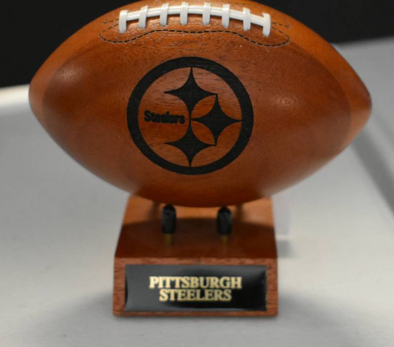 lot 1090 image: Pittsburgh Steelers National Football League Wooden Team Logo Football With Stand - 5 Inches Wide - With Metal Team Name Plaque