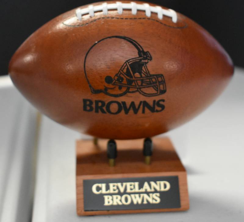 lot 1092 image: Cleveland Browns National Football League Wooden Team Logo Football With Stand - 5 Inches Wide - With Metal Team Name Plaque
