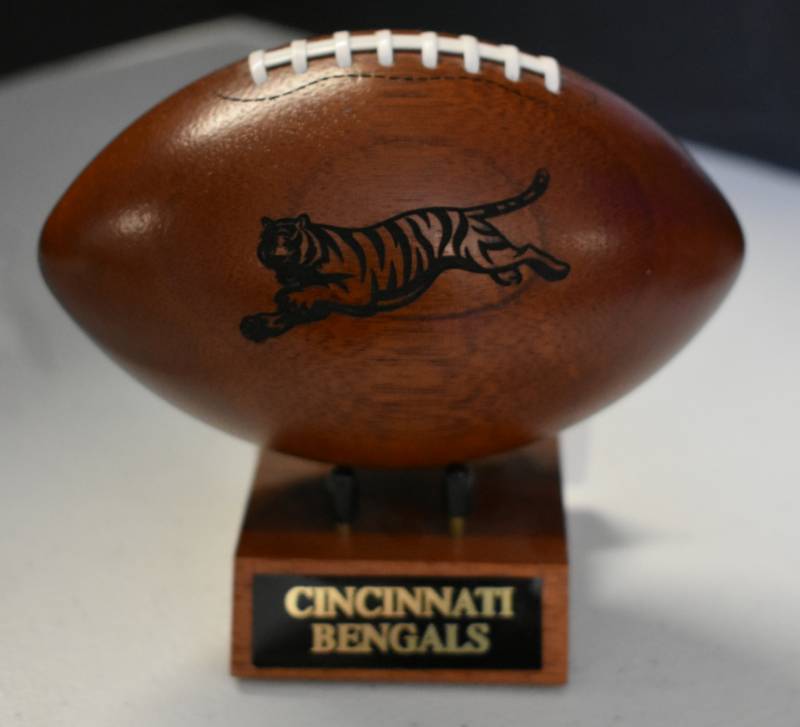 lot 1093 image: Cincinnati Bengals National Football League Wooden Team Logo Football With Stand - 5 Inches Wide - With Metal Team Name Plaque
