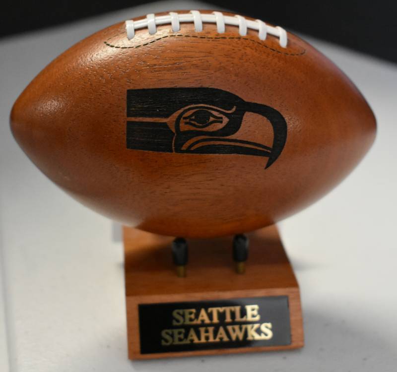 lot 1094 image: Seattle Seahawks National Football League Wooden Team Logo Football With Stand - 5 Inches Wide - With Metal Team Name Plaque