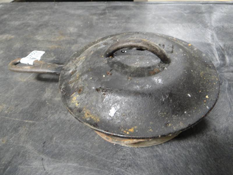 lot 5753 image: #5 Cast iron skillet 8 with a lodge lid.