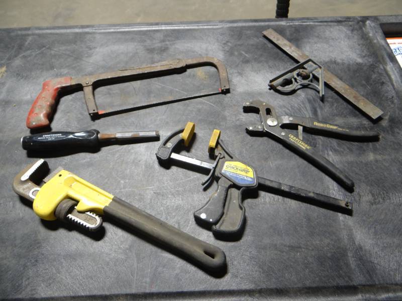 lot 5765 image: Quick grip clamp, 14 pipe wrench, chisel, Craftsman robo grip and more.