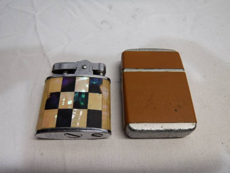 lot 1224 image: 2 refillable lighters, one is checker board and the other looks to have some personal msg on it
