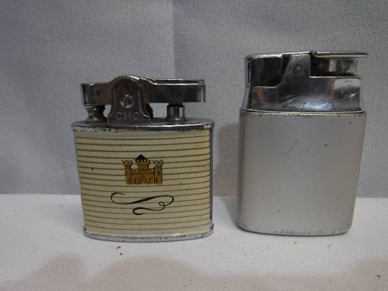 lot 1235 image: 2 refillable lighters, one with a castle on it