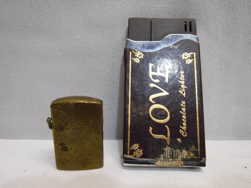 lot 1241 image: brass lighter and candy bar looking lighter