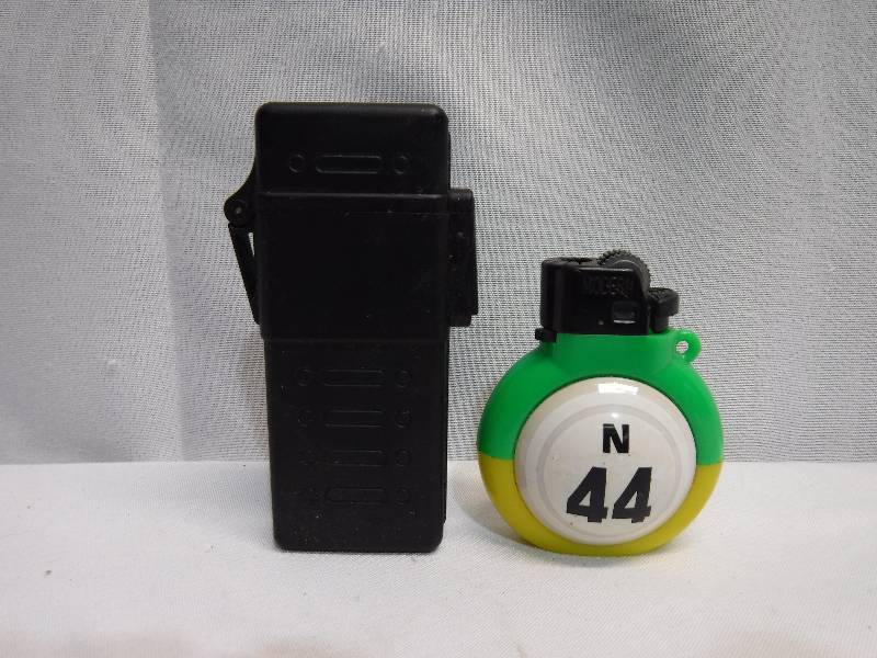 lot 1245 image: black lighter and green and yellow round lighter