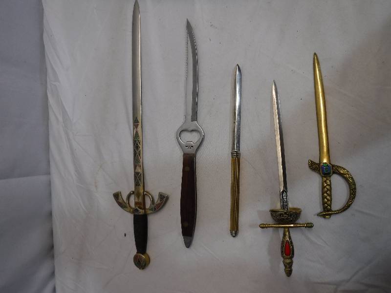 lot 1371 image: Sword looking letter openers- One has a built in bottle opener