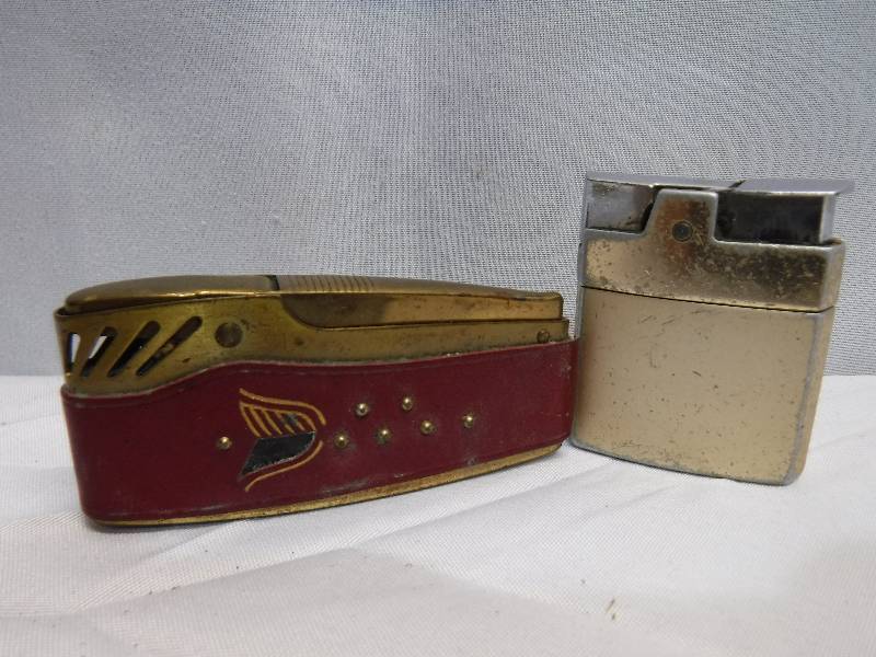 lot 1400 image: Cool shaped table lighter and other lighter