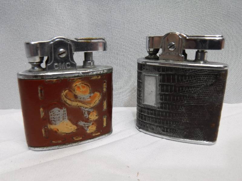 lot 1402 image: Snake skin print and cowboy theme lighters