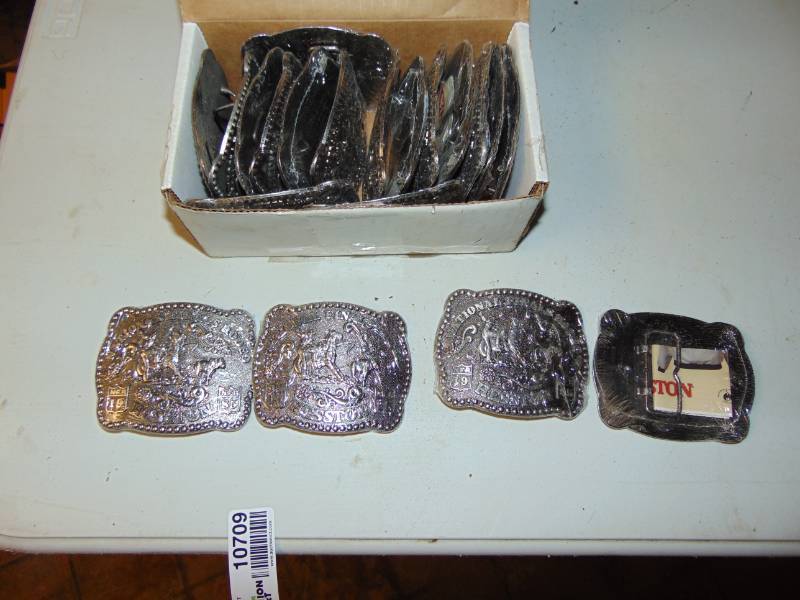 lot 10709 image: Box Of un opened 1985 National Finals Rodeo Hesston Belt Buckles in Plastic Sleeves
