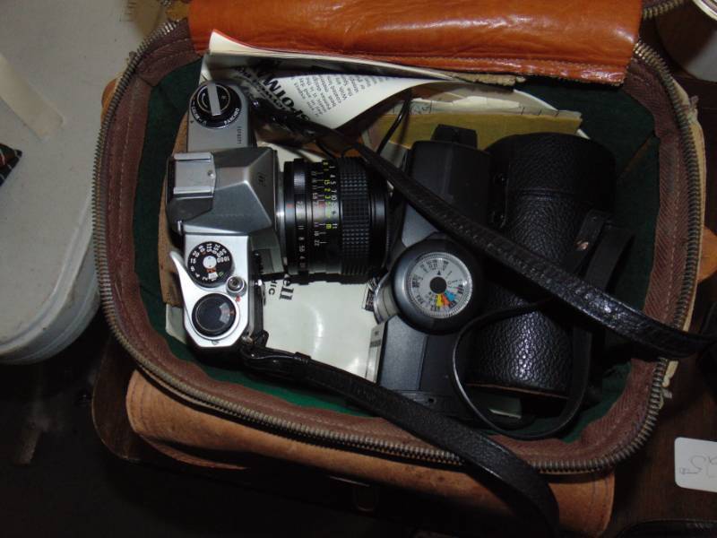 lot 10865 image: Pentax Camera with several attachable lenses and nice leather Carry bag hat all fits in nicely