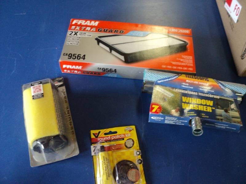 lot 7292 image: (4) ct. mixed lot automotive accessories air filters, window washing squeegie head, patch kit