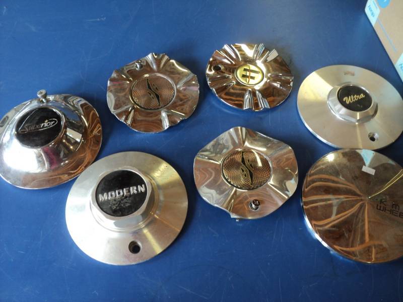 lot 7355 image: (7) ct lot Hub Cap Centers, assorted styles, approx 7-12 diameter