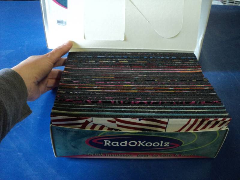 lot 7382 image: (1) case Rad-O-Koolz drink insulators, (6) boxes of (25) foam with bendable metal 9-18 x 3-38, fits around a standard soda can or bottle