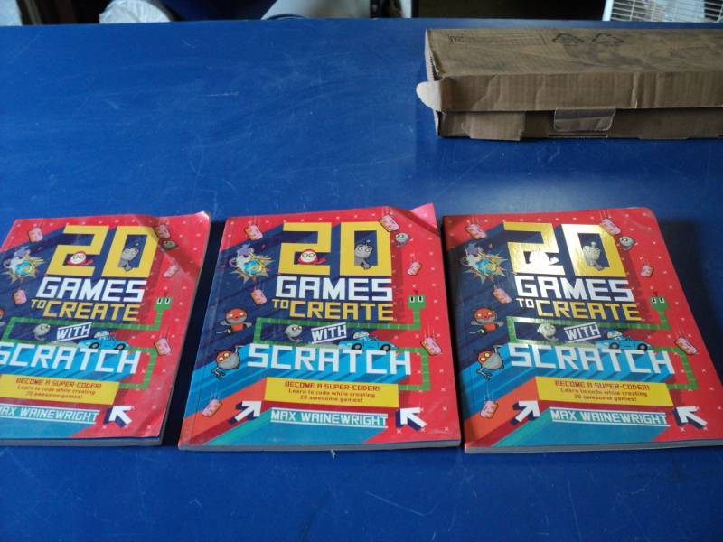 lot 7391 image: (3) ct lot 20 games to create with scratch by Max Wainwright copyright 2016, damage pictured