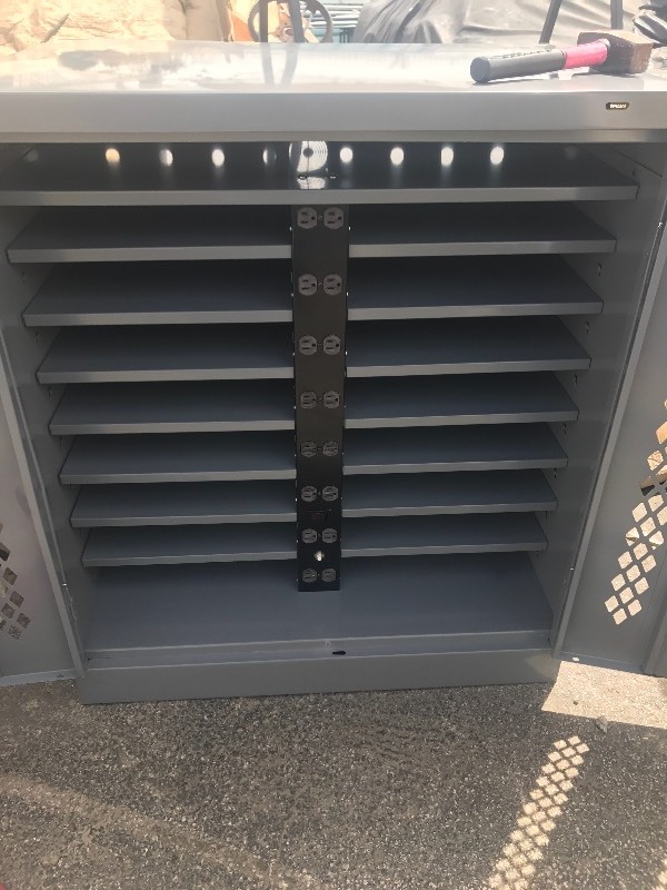 lot 122 image: New gray metal storage cabinet with built-in electrical plug in panel and lockable door latch as pictured