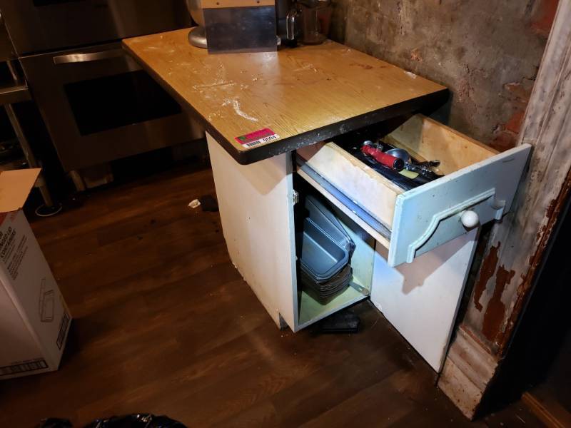 lot 4 image: Table with Various Bread Pans, Scoops, Measuring spoons, and More