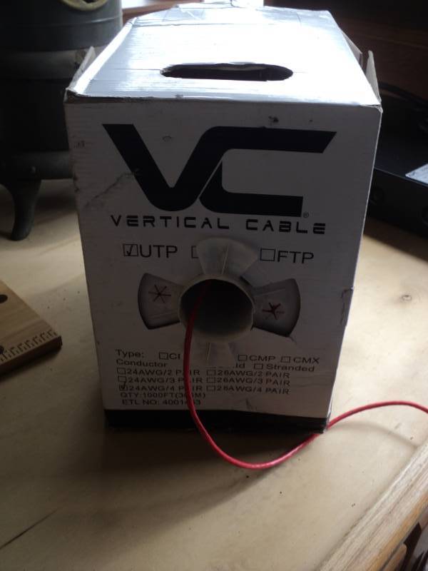 lot 7763 image: (1) box Vertical Cable UTP 24 AWG 4 pair Approx 100, box is damaged- pictured