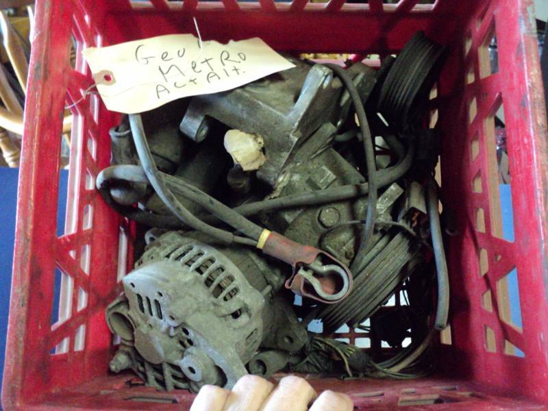 lot 7826 image: Parts for Geo Metro Alternator in a plastic crate