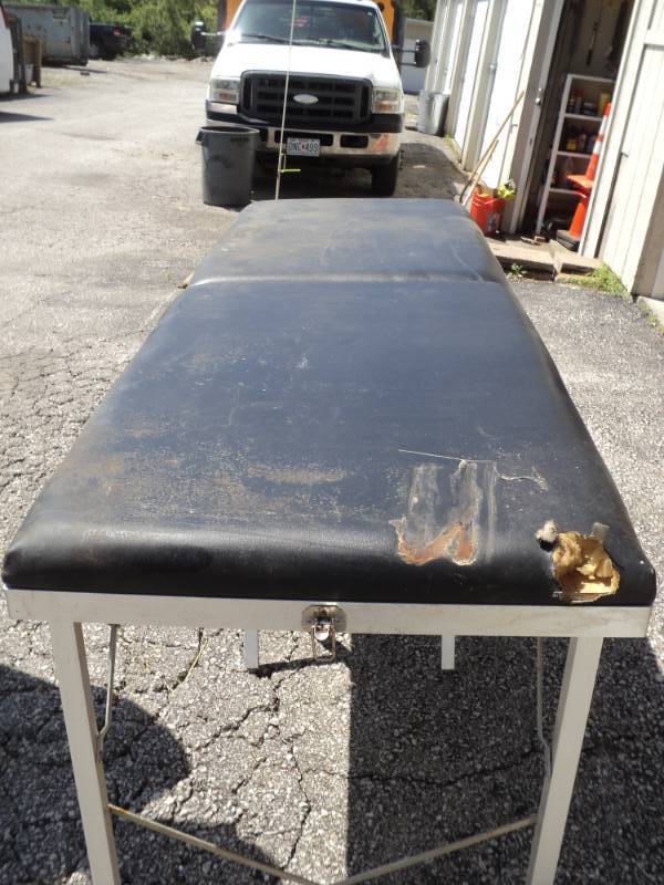 lot 7968 image: Doctors Equipment Brand Massage table approx 6 x 2 x 30, folds up for easy storage (3 x 2 x 9) used, damage pictured