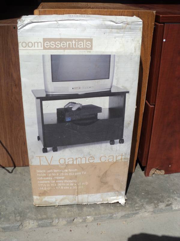 lot 7970 image: Room Essentials TV Game Cart Black Oak Laminate Finish 17-12 x 26-34 x 15, un-assembled, damaged box