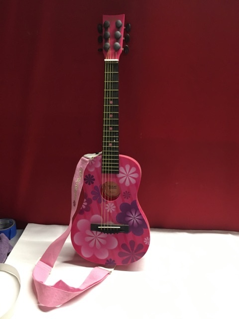 lot 3646 image: Pink Flower Power First Act Guitar with Strap