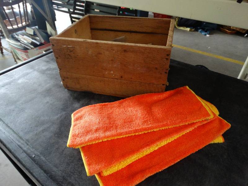 lot 17418 image: Wooden box with cds and towels.