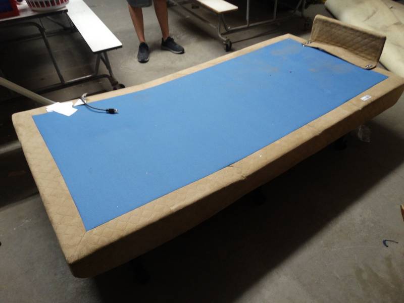 lot 17585 image: Adjustable bed base on wheels comes with a remote.