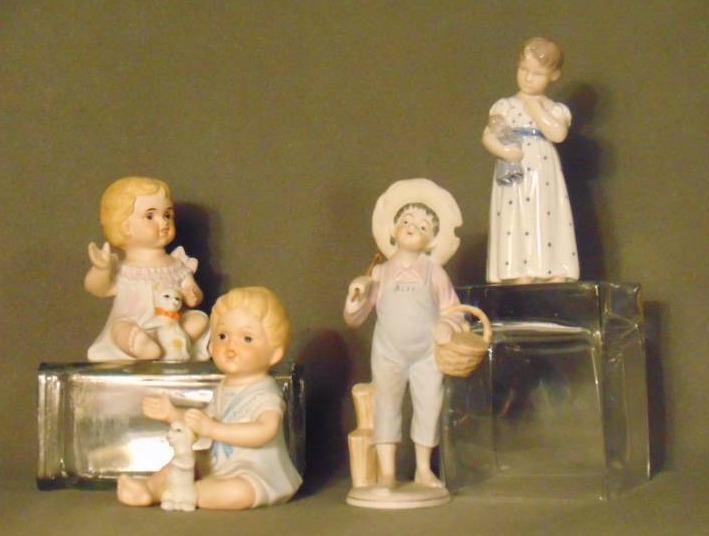 lot 10006 image: Royal Copenhagen Denmark #3539 Figurine Girl with Doll (found on-line for $100), Ucagco Boy Fishing Figurine