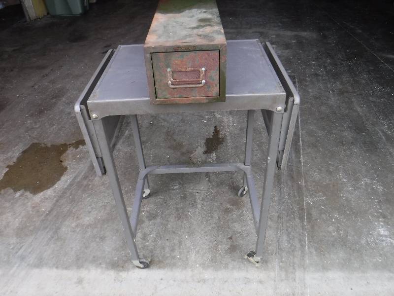 lot 12062 image: Metal rolling table with drop down sides and a file box