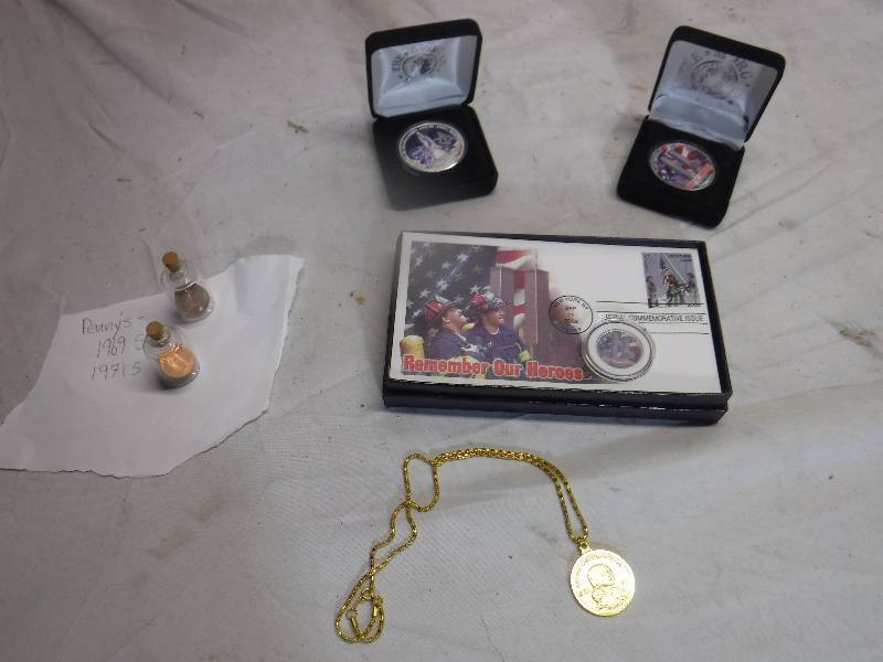 lot 12197 image: 9-11 comemertaive coin, Space shuttle columbia coin, 1969 and 1971 pennys in jars and coin necklace