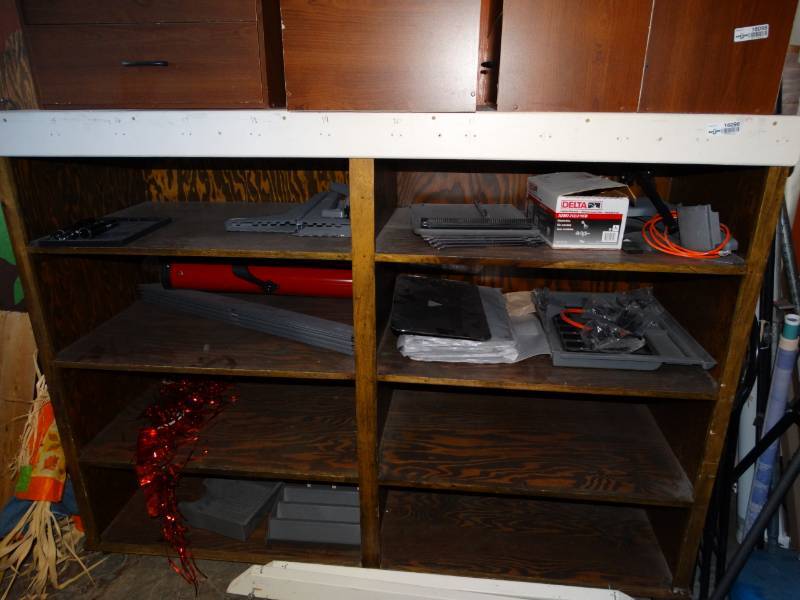 lot 16096 image: Large wooden cabinet on wheels with contents, cabinets on top not included.