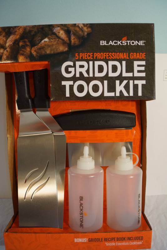 lot 1377 image: Blackstone Professional Griddle Kit- New in box -Includes 2 spatulas , one scraper, and two bottles