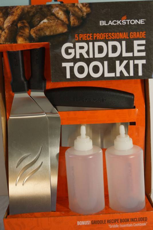 lot 1378 image: Blackstone Professional Griddle Kit- New in box -Includes 2 spatulas , one scraper, and two bottles