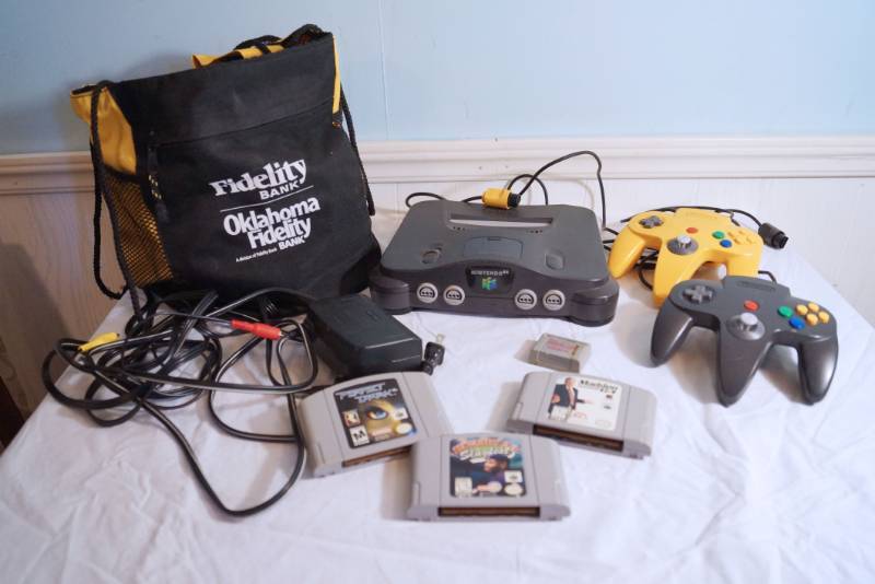 lot 1401 image: Nintendo 64-two controllers-three games-storage bag-untested