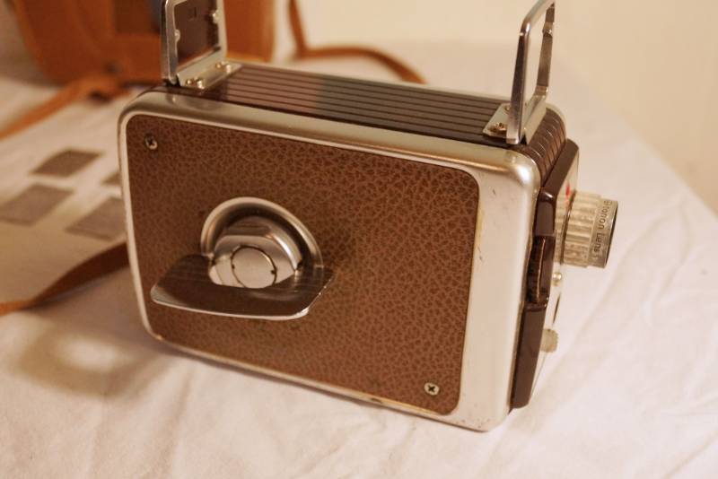 lot 1440 image: Kodak Brownie Movie Camera- in original box with leather case-many extras-It does wind and turn -See video-rare find