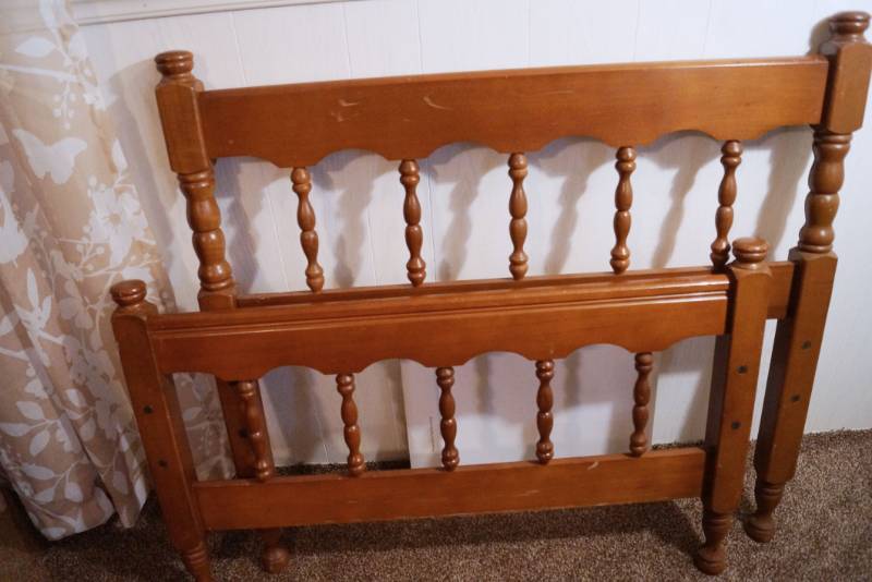 lot 1464 image: Wooden Twin Bed with metal Frame and Trundle Roll out that pops up to make a King sized bed- no mattresses