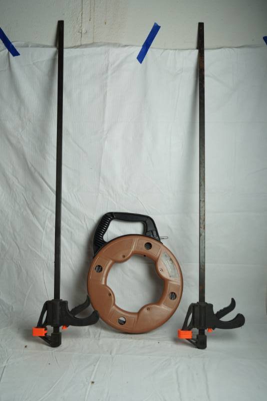 lot 1639 image: Lot of Misc. Items - Southwire 125 Fish Tape and 2 Bar Clamps
