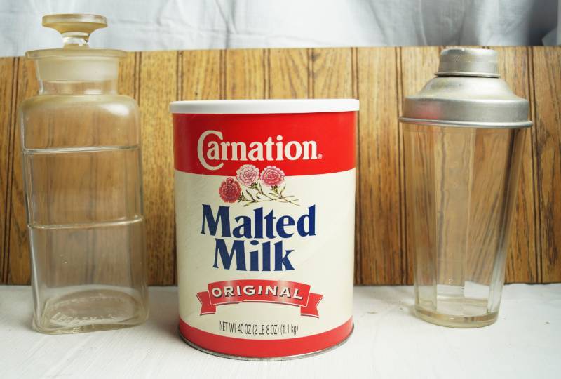 lot 1622 image: Vintage Soda Fountain  Apothecary Items - Carnation Malted Milk (sealed) and 2