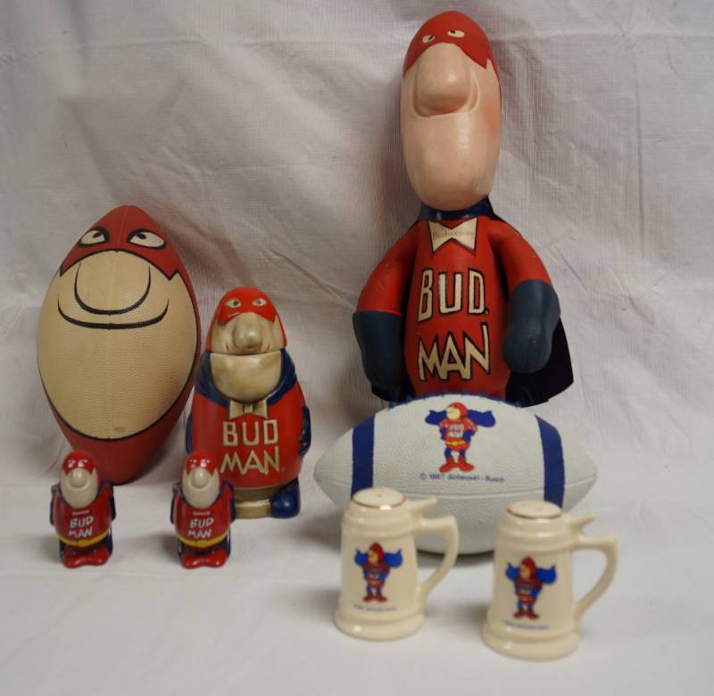 lot 2074 image: Lot of Bud Man Budweiser Memorabilia - Footballs, Salt & Pepper, Ceramarte Steins and More