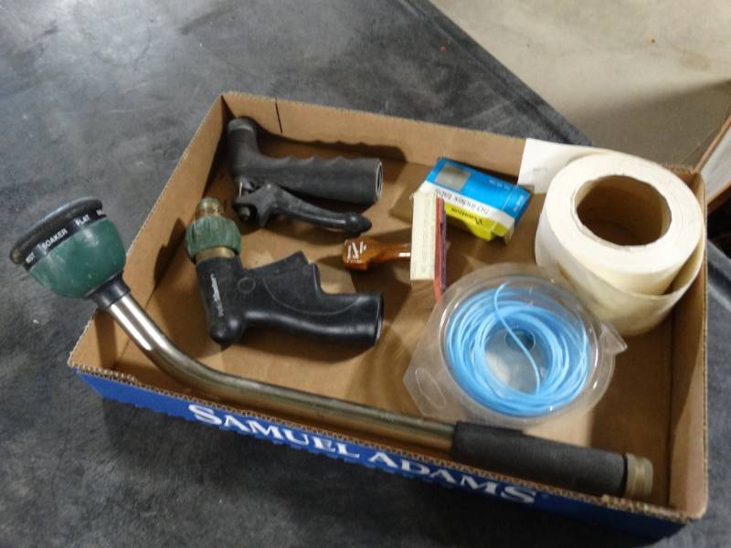 lot 17648 image: Water hose sprayers, weed eater string, & paper role.