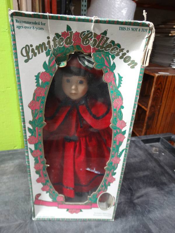 lot 17839 image: Limited collection genuine porcelain doll with matching ornament.